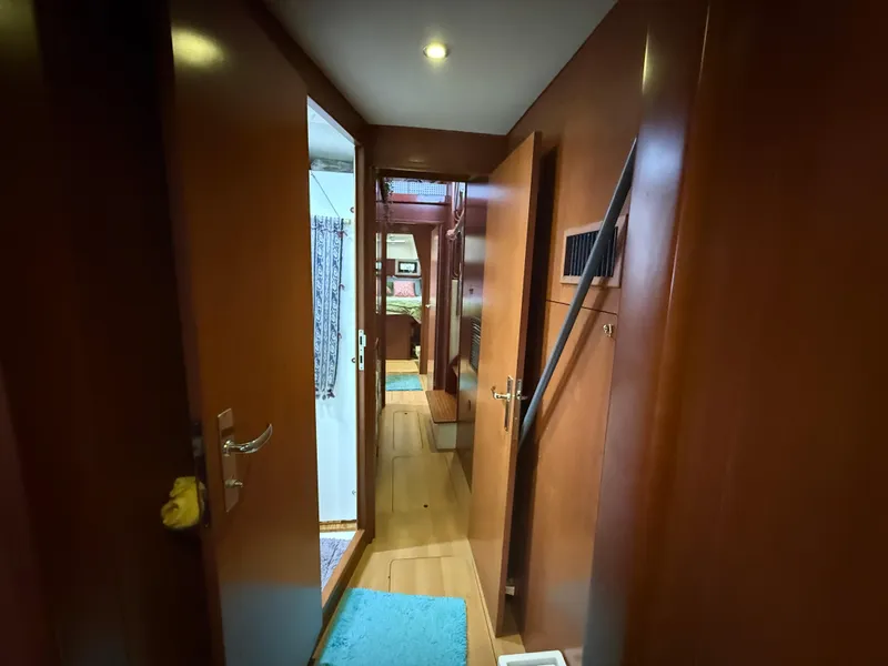 Slide: The Image of Cozy bedroom in 2013 Leopard 48 yacht with teal bedding and wooden cabinetry. - 31