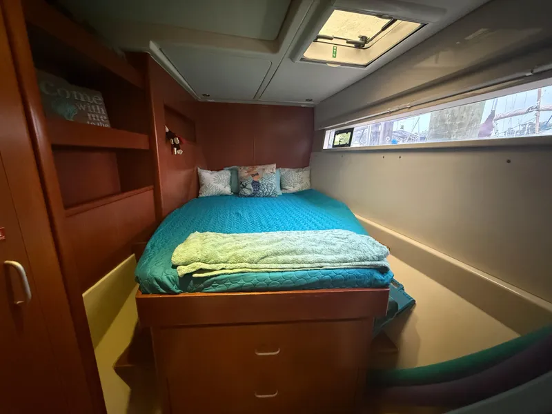 Slide: The Image of Compact bathroom in a 2013 Leopard 48 yacht with sink, toilet, and storage shelves. - 33