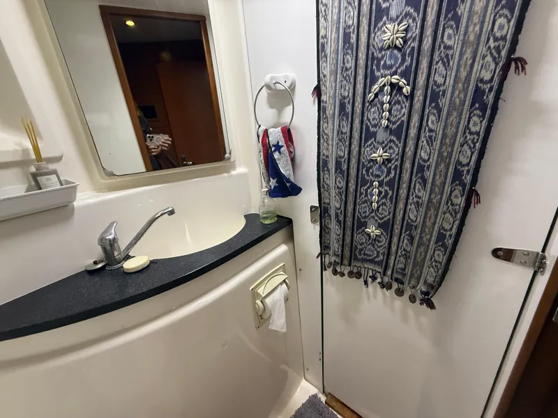 Slide: The Image of Hallway view inside 2013 Leopard 48 yacht, featuring a bedroom and washing machine. - 34