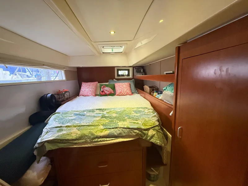 Slide: The Image of Cozy bedroom interior on 2013 Leopard 48 yacht with wooden decor and comfortable bedding. - 42