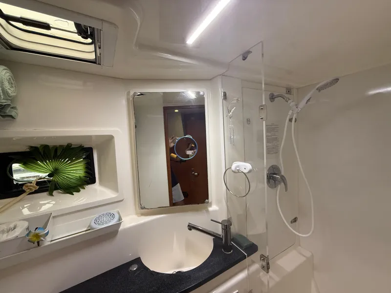 Slide: The Image of Leopard 48 yacht kitchen interior, featuring modern appliances and wooden cabinetry, 2013 model. - 52