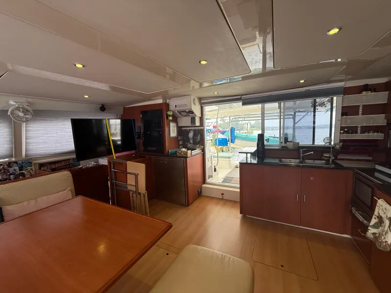 Slide: The Image of Interior of a 2013 Leopard 48 yacht with cozy seating and a wooden table. - 58