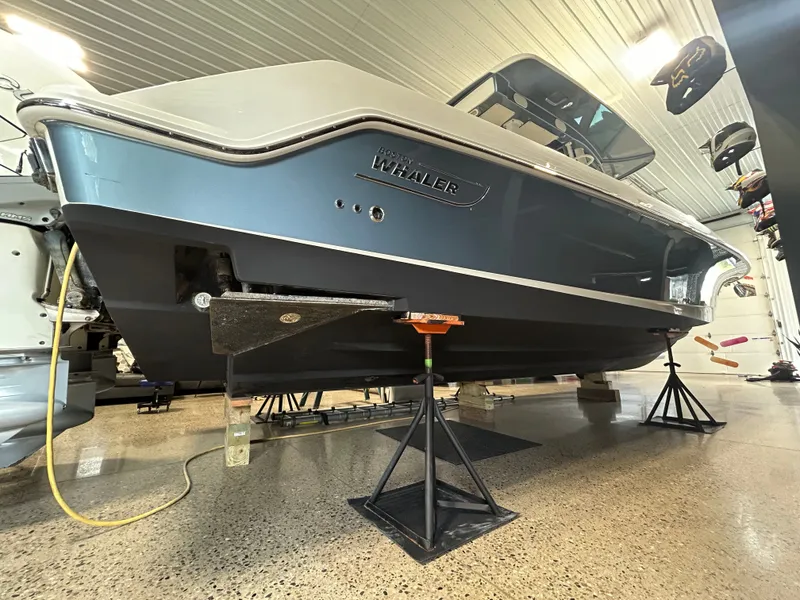 Slide: The Image of Boston Whaler 380 Outrage 2019 on stands in a workshop. - 47
