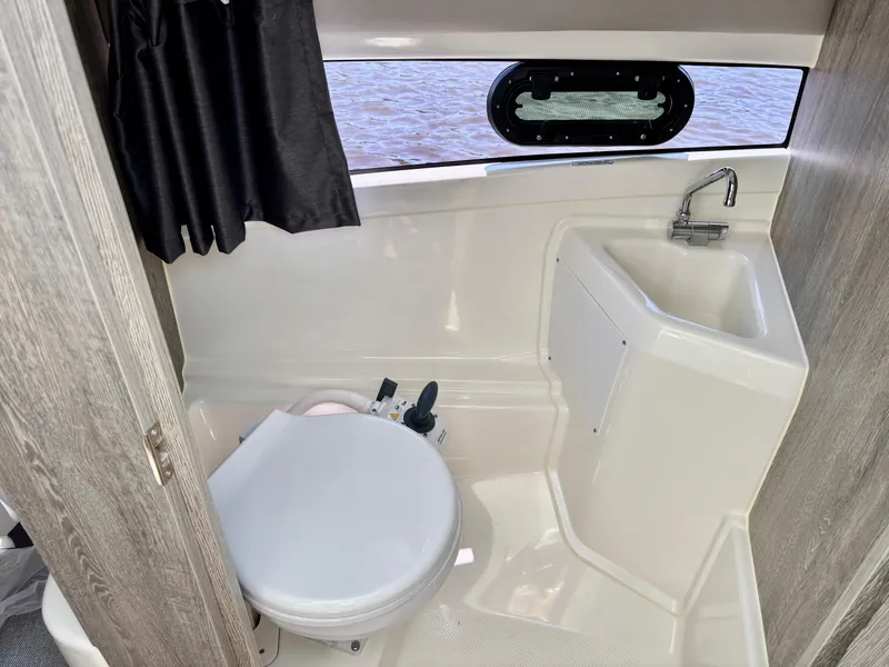 Slide: The Image of 2025 Bayliner TROPHY 25 EXPLORER boat bathroom with toilet and sink. - 3