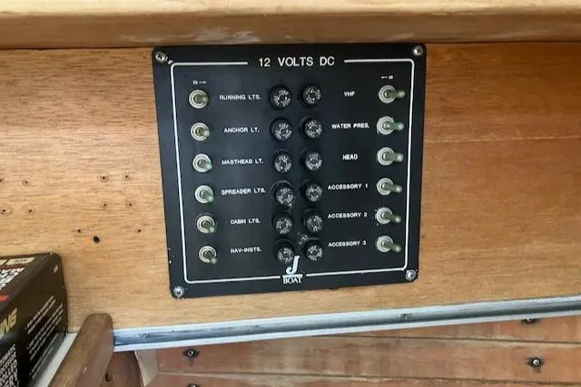 Slide: The Image of Control panel of a 1981 J Boats 30, featuring 12-volt DC switches. - 11
