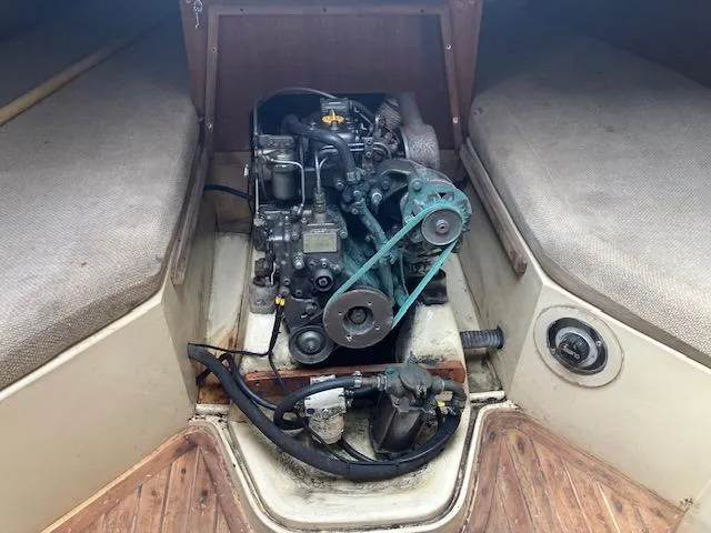 Slide: The Image of Engine compartment of a 1981 J Boats 30 sailboat, featuring visible engine components. - 12