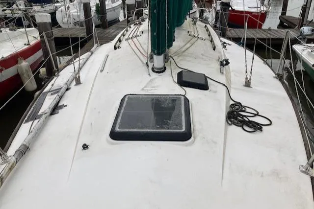 Slide: The Image of 1981 J Boats 30 sailboat deck with hatch and rigging, docked at marina. - 5