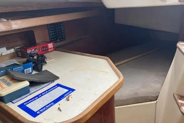 Slide: The Image of Interior cabin of a 1981 J Boats 30, featuring a compact sleeping area and storage space. - 8