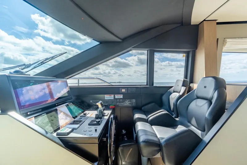 Slide: The Image of Luxurious helm of 2024 Ferretti Yachts 720 with modern navigation controls and leather seating. - 39