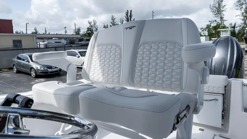 Slide: The Image of 2026 Tidewater 256 CC Adventure boat with luxurious white seating and modern design. - 11
