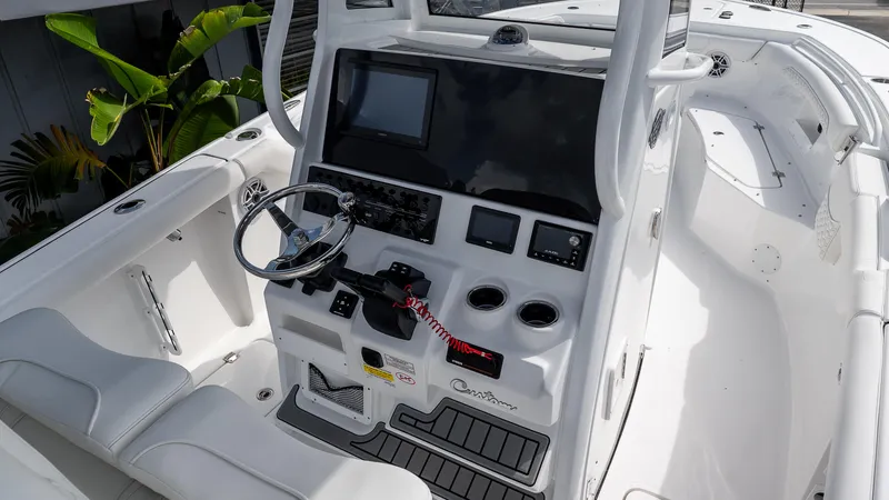 Slide: The Image of 2026 Tidewater 256 CC Adventure boat cockpit with modern controls and sleek design. - 14