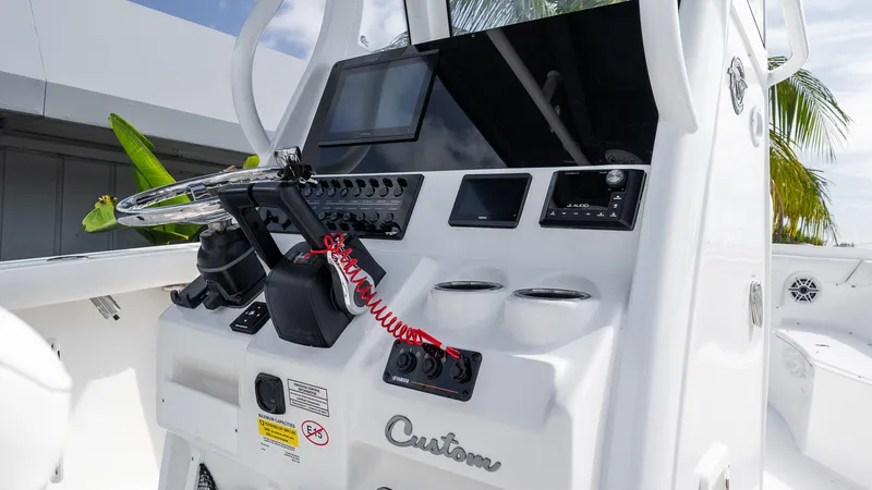 Slide: The Image of 2026 Tidewater 256 CC Adventure boat console with steering wheel and electronic controls. - 15