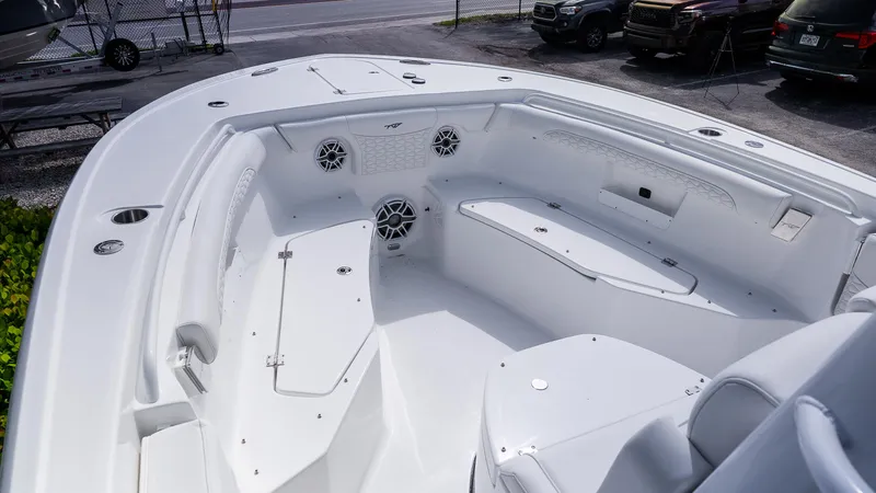 Slide: The Image of 2026 Tidewater 256 CC Adventure boat interior with seating and storage compartments. - 19