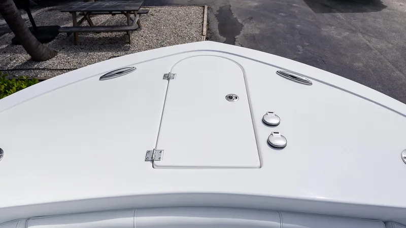 Slide: The Image of Bow of 2026 Tidewater 256 CC Adventure boat with storage hatch and cleats. - 23