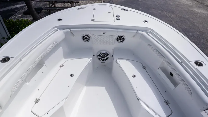 Slide: The Image of 2026 Tidewater 256 CC Adventure boat interior with seating and speakers. - 25