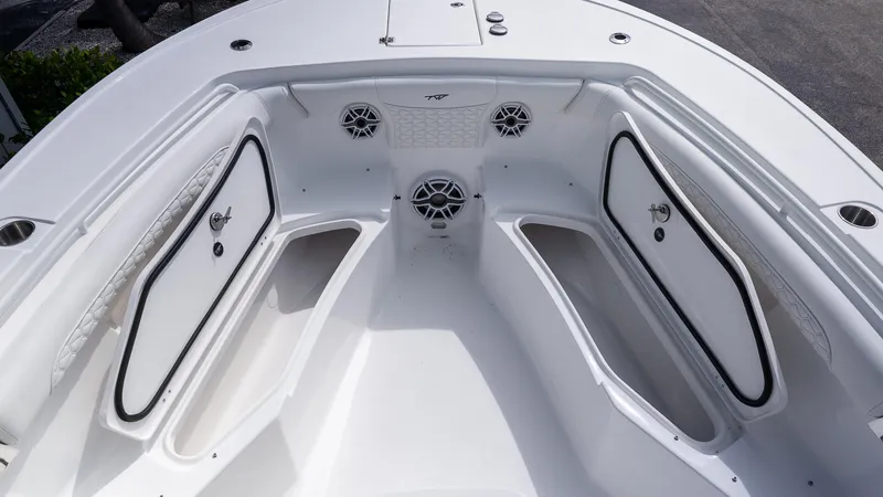 Slide: The Image of 2026 Tidewater 256 CC Adventure boat interior with storage compartments and speakers. - 26