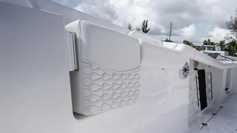 Slide: The Image of 2026 Tidewater 256 CC Adventure boat interior with white cushioned seating and geometric design. - 27