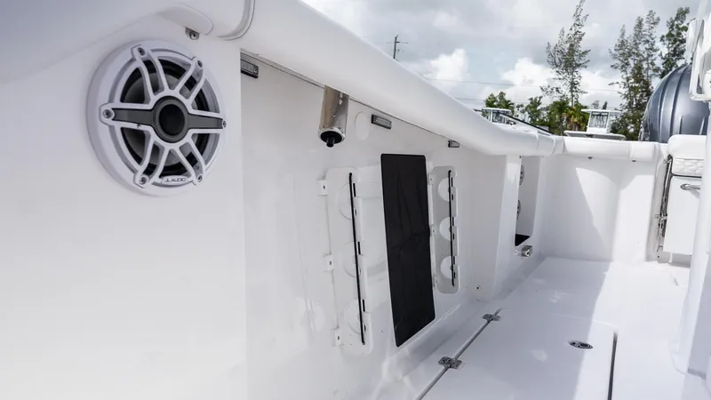 Slide: The Image of 2026 Tidewater 256 CC Adventure boat interior with speaker and storage compartments. - 28