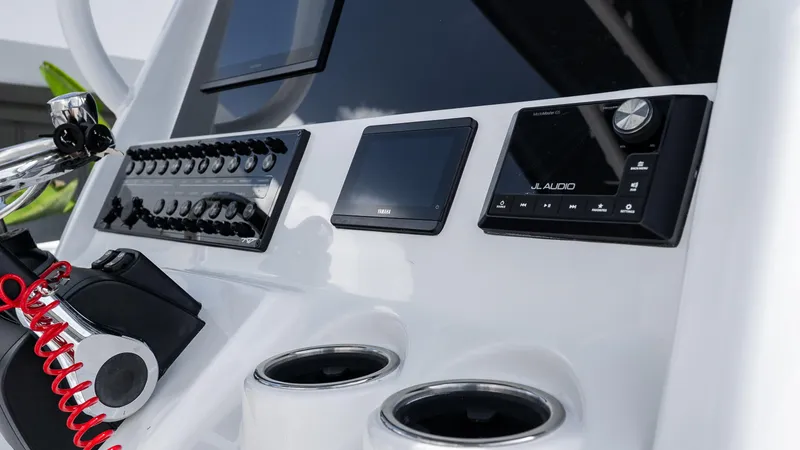 Slide: The Image of Control panel of 2026 Tidewater 256 CC Adventure boat with audio system and displays. - 29