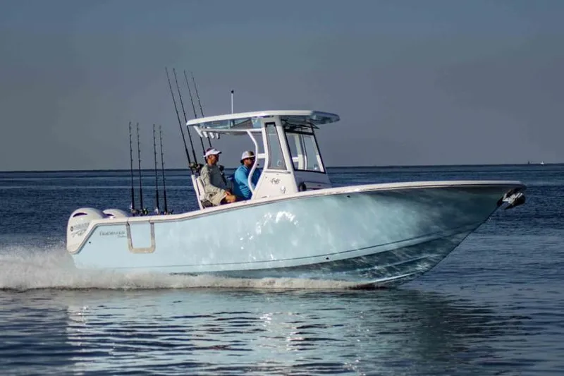 Slide: The Image of 2026 Tidewater 256 CC Adventure boat cruising on calm waters. - 31