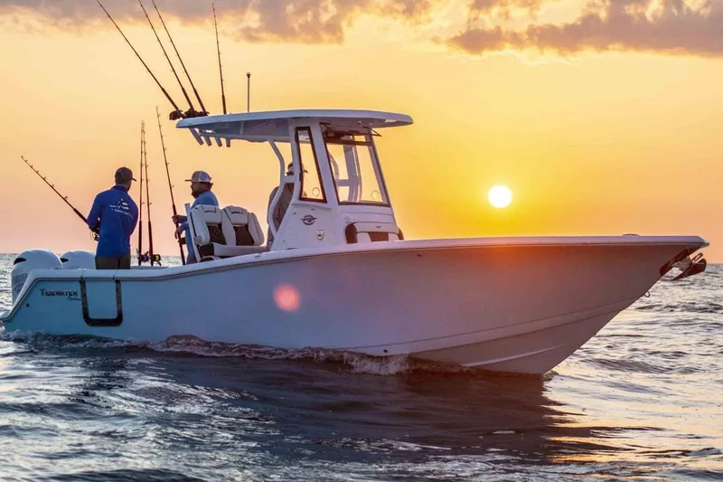 Slide: The Image of 2026 Tidewater 256 CC Adventure boat at sunset with two people fishing. - 33