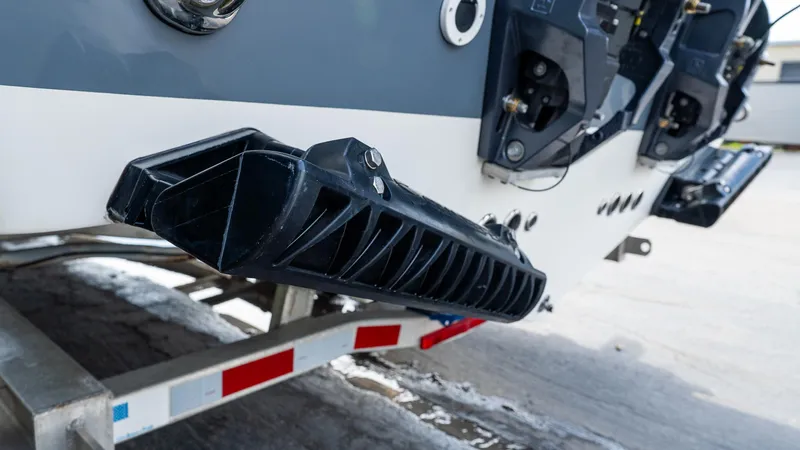 Slide: The Image of 2026 Tidewater 256 CC Adventure boat on trailer, showcasing rear details and components. - 5