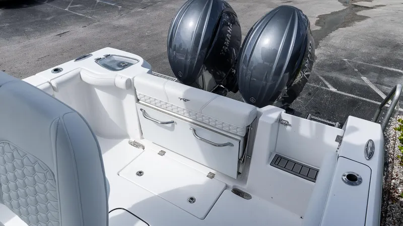 Slide: The Image of 2026 Tidewater 256 CC Adventure boat with dual outboard motors, white interior. - 7