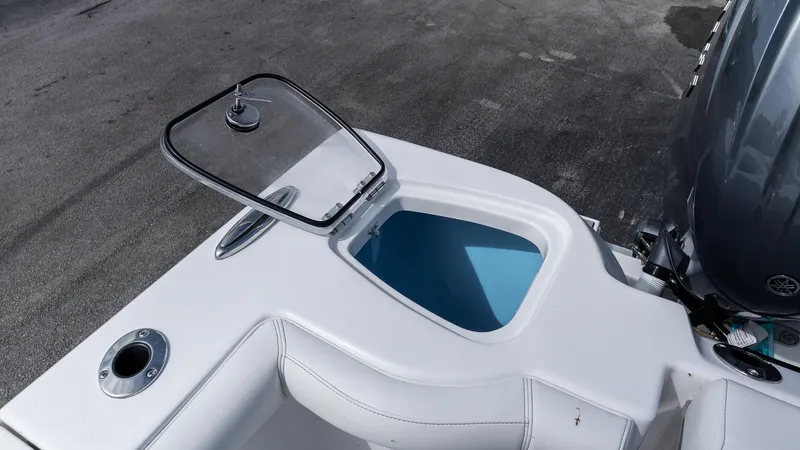Slide: The Image of Open hatch on 2026 Tidewater 256 CC Adventure boat, showing storage compartment. - 8