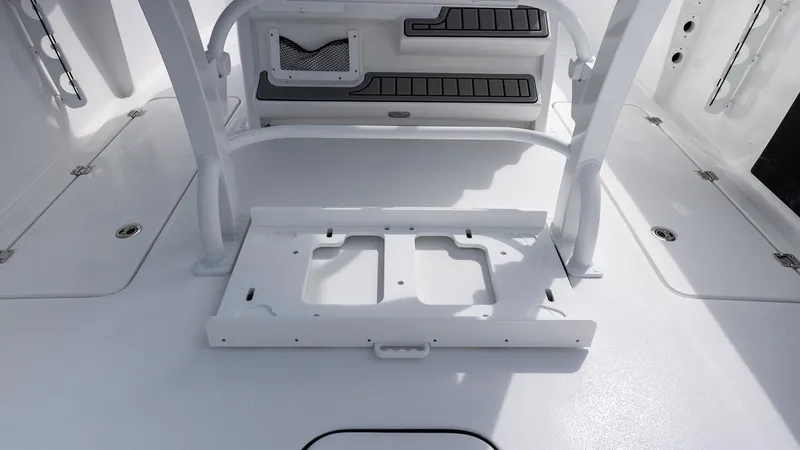 Slide: The Image of 2026 Tidewater 256 CC Adventure boat interior, featuring sleek white deck and storage compartments. - 9