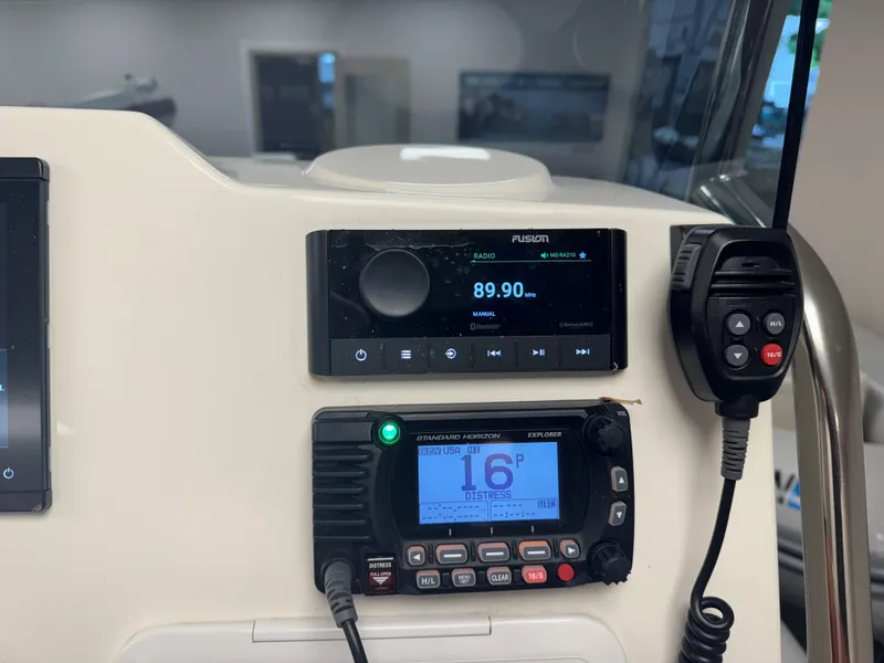 Slide: The Image of Control panel of a 2022 Brig Navigator 570 boat with radio and communication devices. - 18