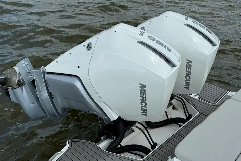 Slide: The Image of Twin Mercury outboard engines on 2023 Sea Ray SDX 290 boat, docked on water. - 14