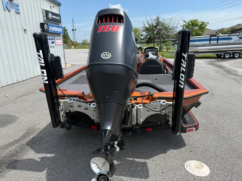 Slide: The Image of 2020 Vexus AVX 1980 boat with 150 horsepower engine and Talon anchors, parked outdoors. - 13