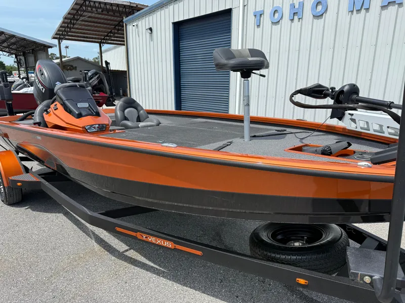 Slide: The Image of 2020 Vexus AVX 1980 boat in orange, parked at Toho Marine, featuring Suzuki engine. - 2