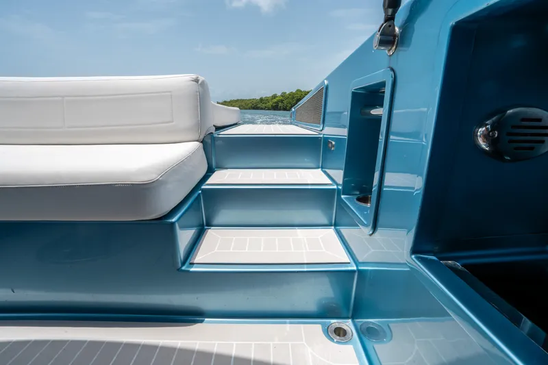 Slide: The Image of VanDutch 30 yacht interior, blue steps and white seating, 2018 model, sunny day. - 10
