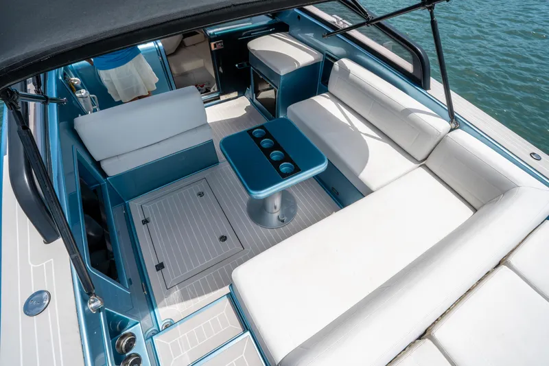 Slide: The Image of Luxurious 2018 VanDutch 30 yacht interior with white seating and blue accents on the water. - 12