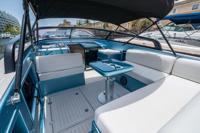 Slide: The Image of 2018 VanDutch 30 yacht interior with white seating and blue accents in a marina setting. - 13