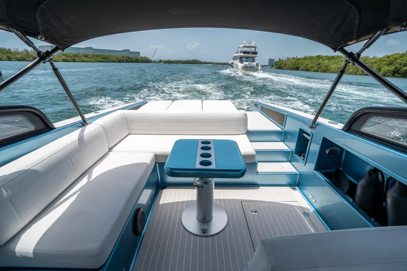 Slide: The Image of Luxurious 2018 VanDutch 30 yacht interior with white seating and blue accents on open water. - 14