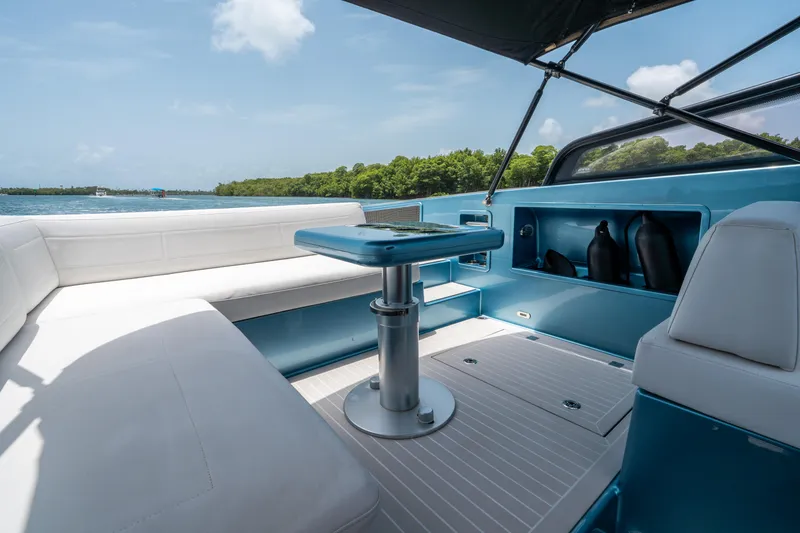Slide: The Image of Luxurious 2018 VanDutch 30 yacht interior with white seating and sleek blue accents. - 17