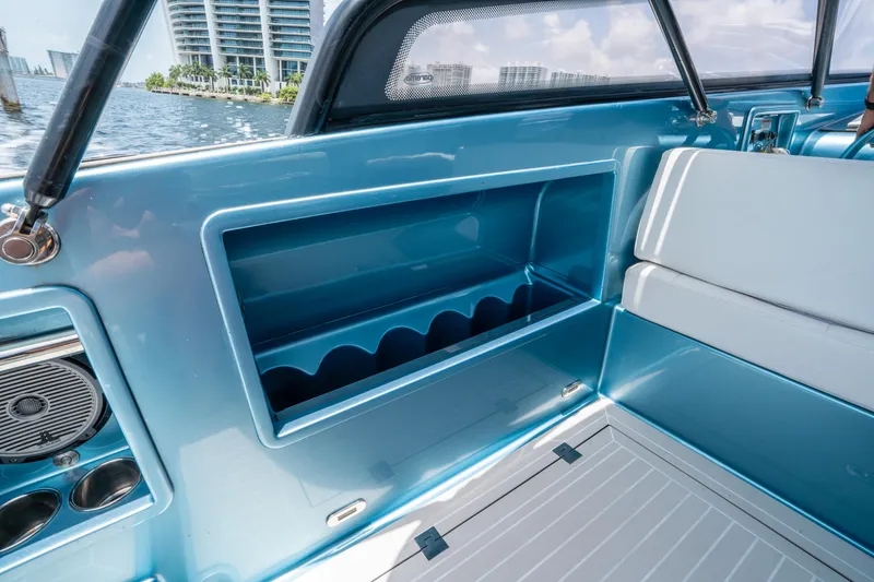 Slide: The Image of Interior of 2018 VanDutch 30 boat with blue storage compartment and seating. - 18