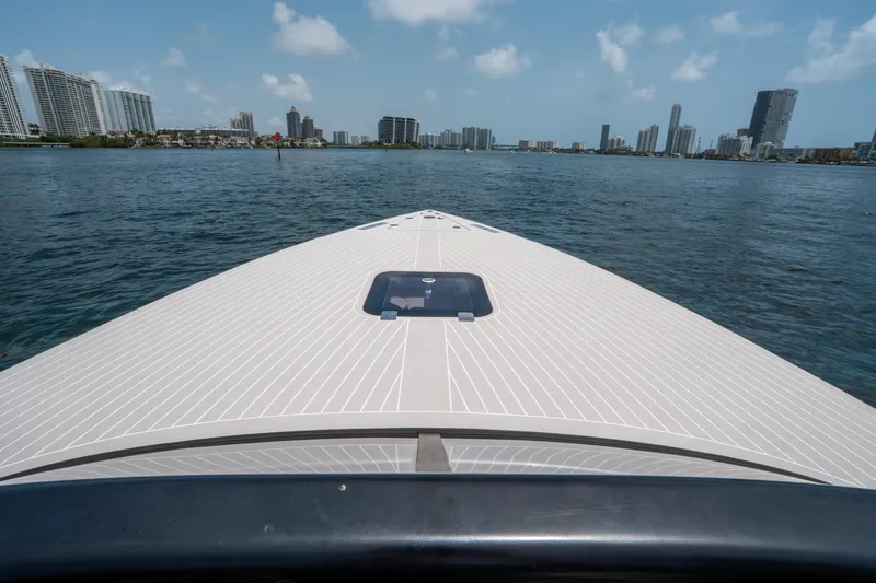 Slide: The Image of VanDutch 30 yacht cruising on water with city skyline in background, 2018 model. - 22