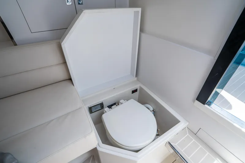 Slide: The Image of 2018 VanDutch 30 yacht interior with compact toilet and seating area. - 27