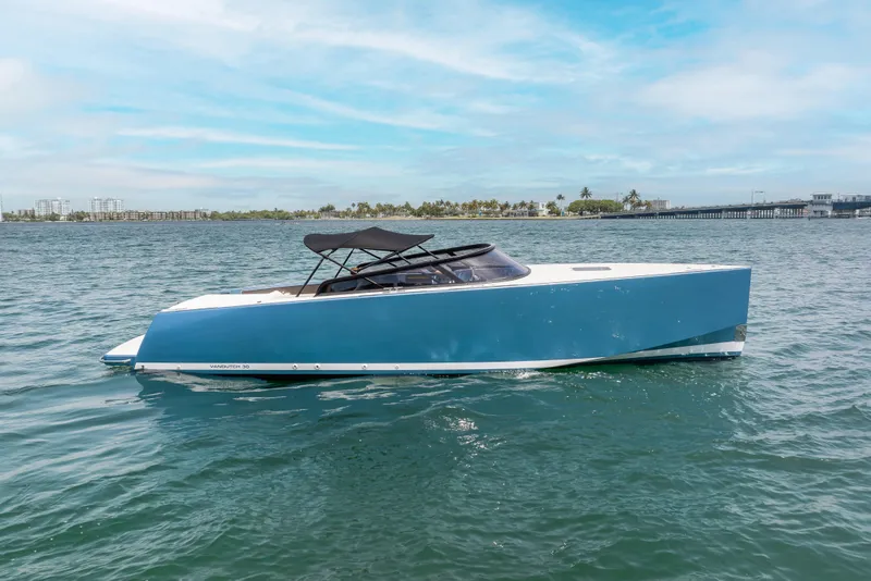 Slide: The Image of 2018 VanDutch 30 yacht on calm water under a clear blue sky. - 4
