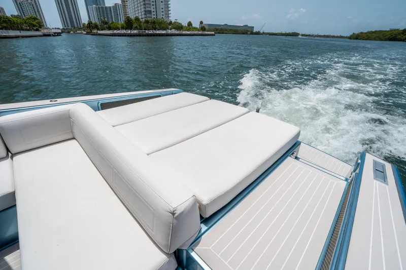 Slide: The Image of VanDutch 30 yacht cruising on water, featuring luxurious white seating, 2018 model. - 7