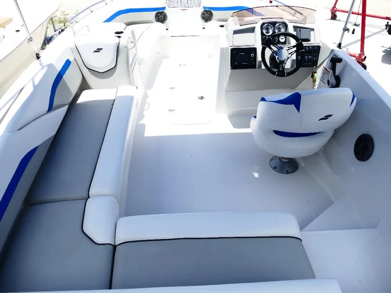 Slide: The Image of 2021 Starcraft SVX 211 OB boat interior with white and blue seating, modern dashboard. - 10