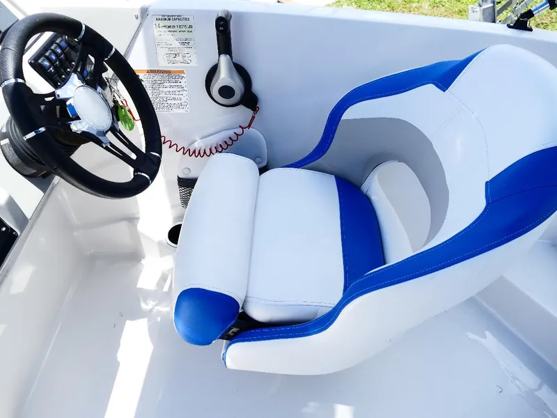 Slide: The Image of 2021 Starcraft SVX 211 OB boat interior with blue and white captain's seat and steering wheel. - 15