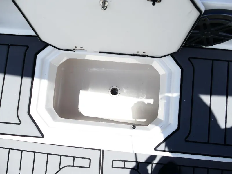 Slide: The Image of Open storage compartment on 2021 Starcraft SVX 211 OB boat deck. - 21