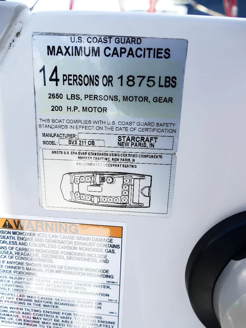 Slide: The Image of 2021 Starcraft SVX 211 OB capacity label, 14 persons or 1875 lbs, U.S. Coast Guard compliant. - 25