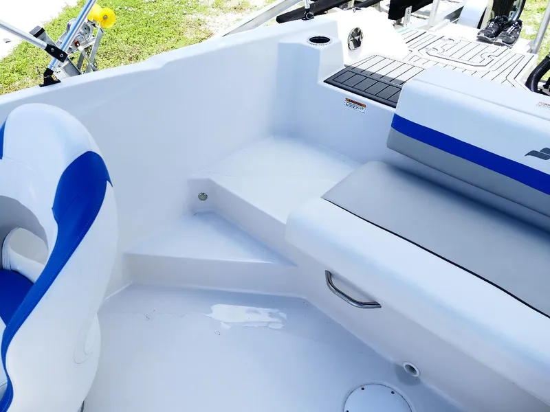Slide: The Image of 2021 Starcraft SVX 211 OB boat interior with blue and white seating. - 26