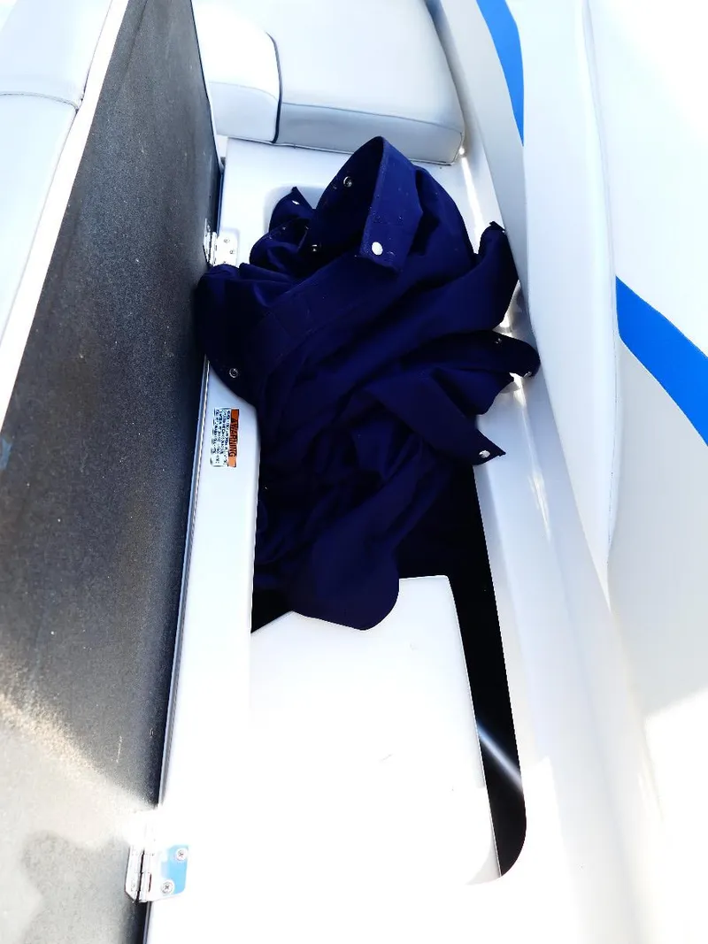 Slide: The Image of Storage compartment in 2021 Starcraft SVX 211 OB boat with blue fabric inside. - 27