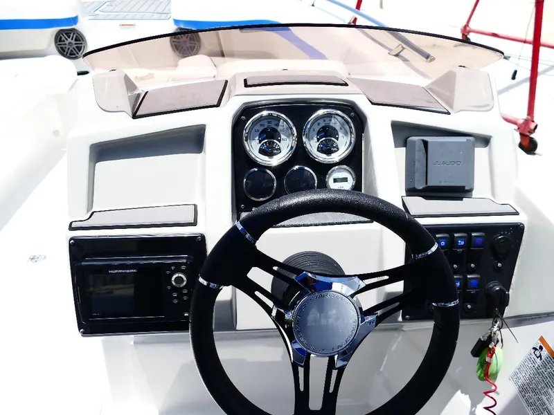 Slide: The Image of 2021 Starcraft SVX 211 OB boat dashboard with steering wheel and control panel. - 9